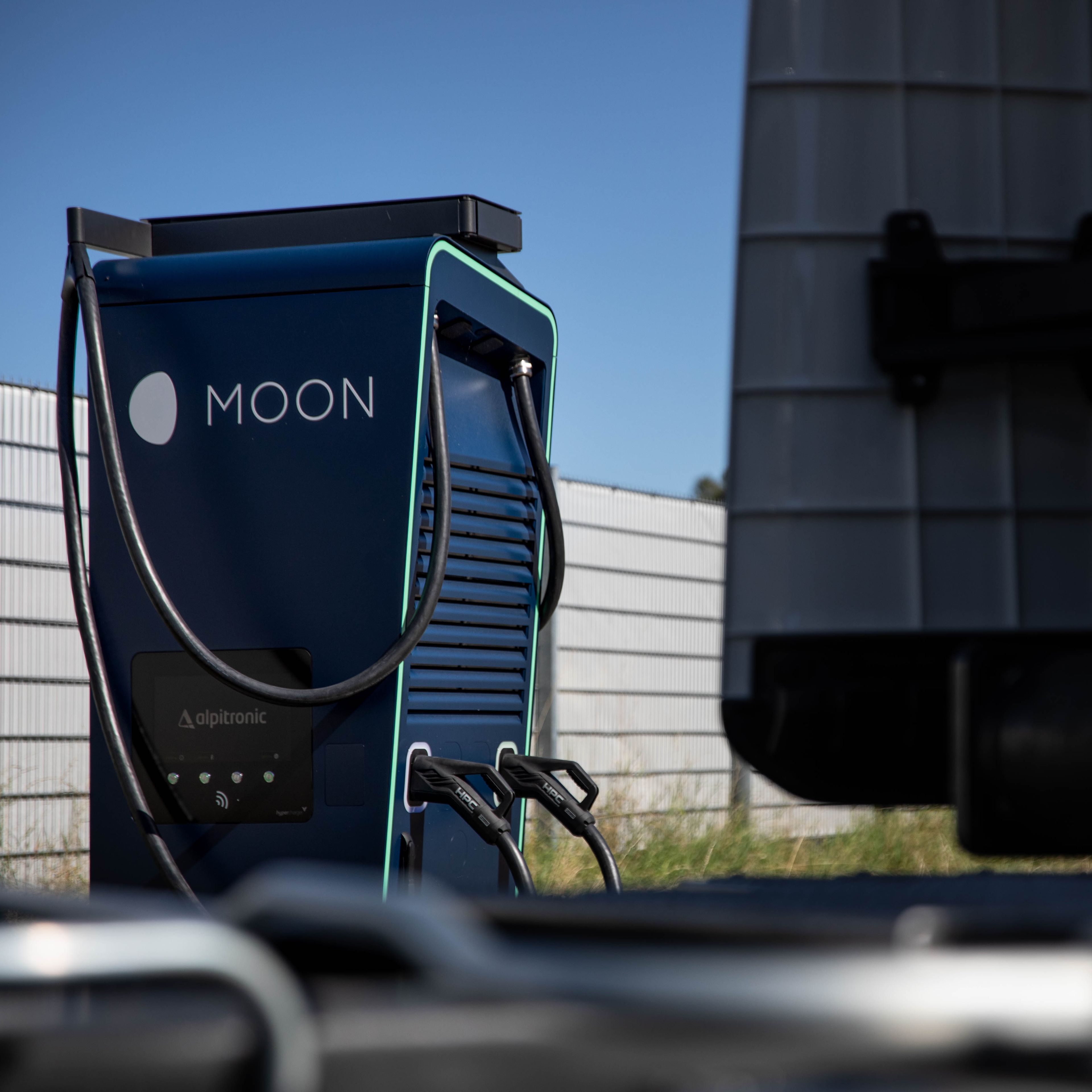 a truck stands in front of a HYC 200-400 fast charging station